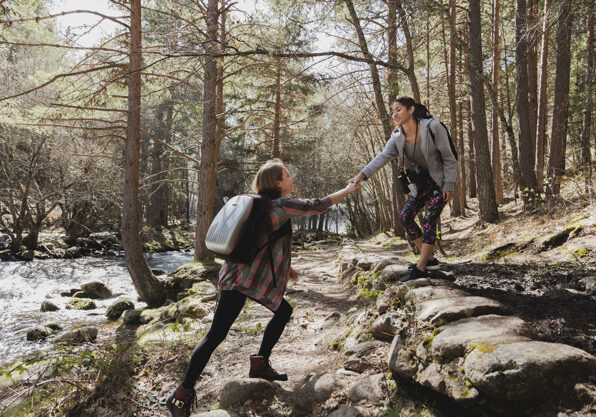 girl-helping-her-friend-outdoors_23-2147617386